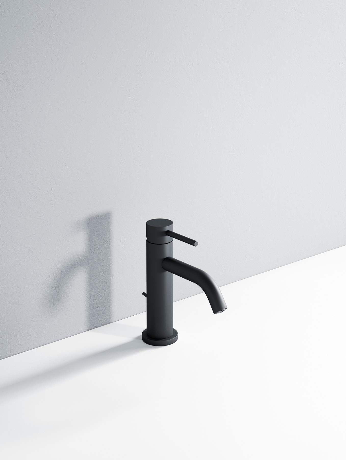 Rubinetto nero minimalista installato su lavabo bianco.