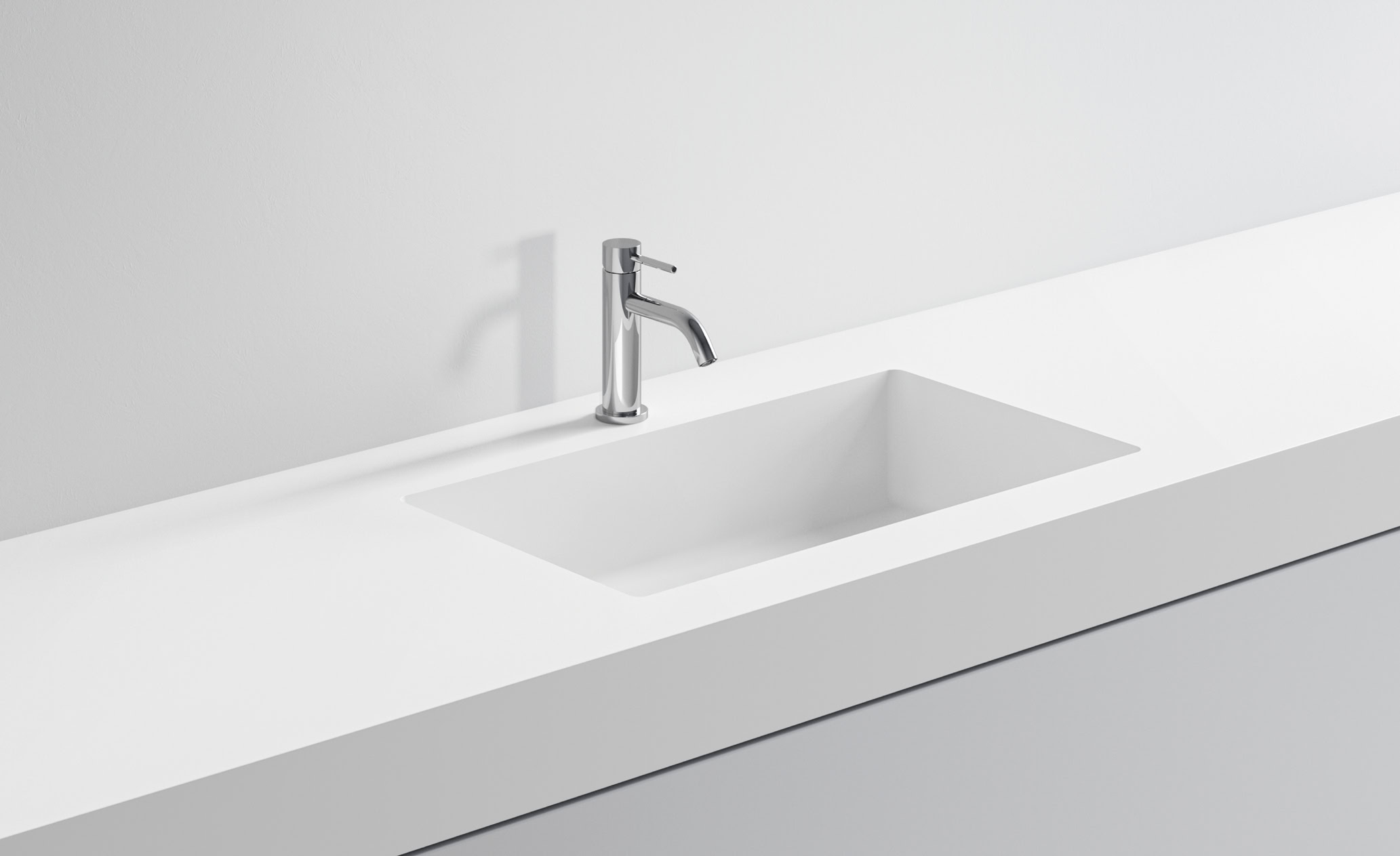 Lavabo bianco minimalista con rubinetto in acciaio inox.