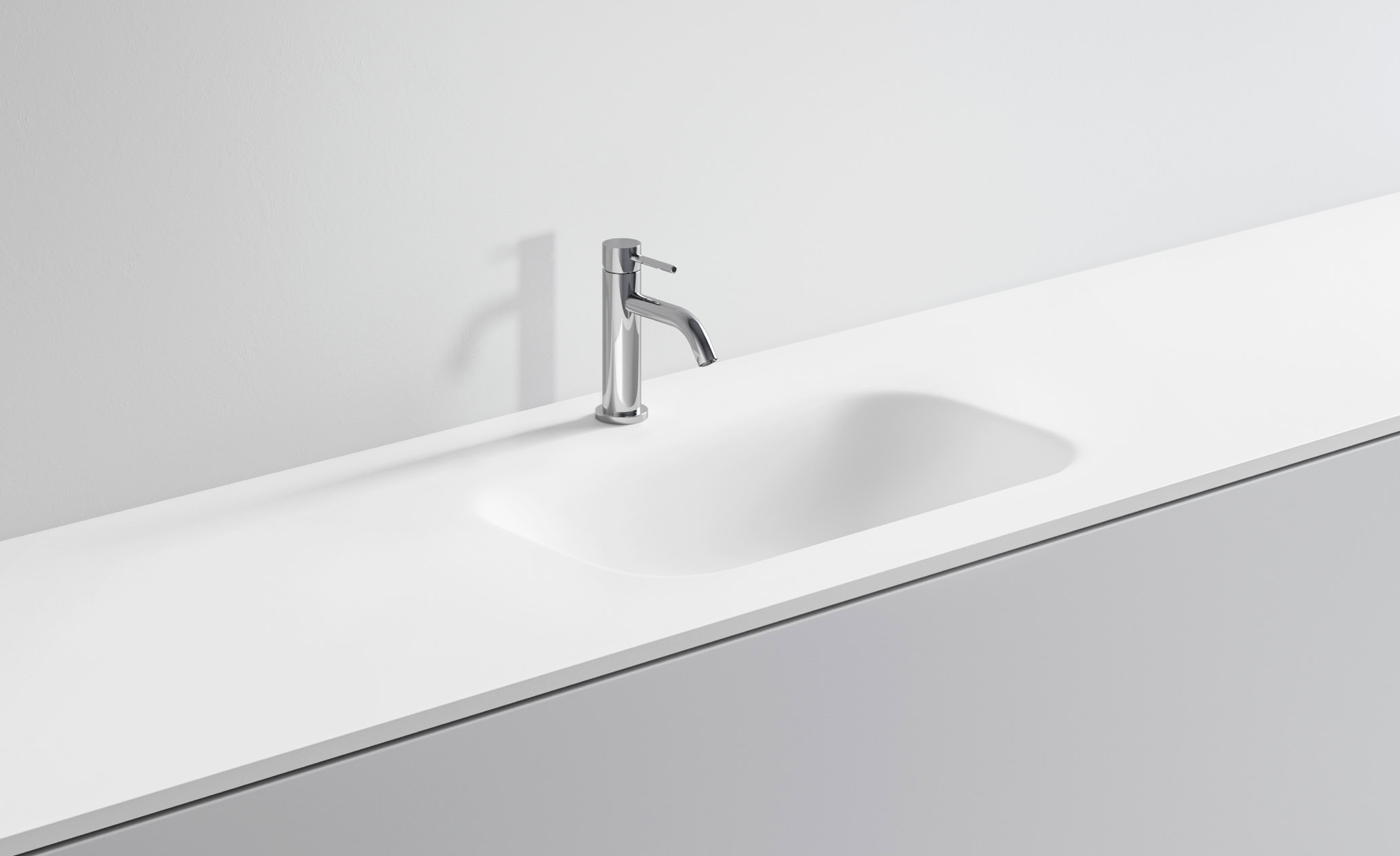 Lavandino bianco con rubinetto in acciaio inox in bagno minimalista.