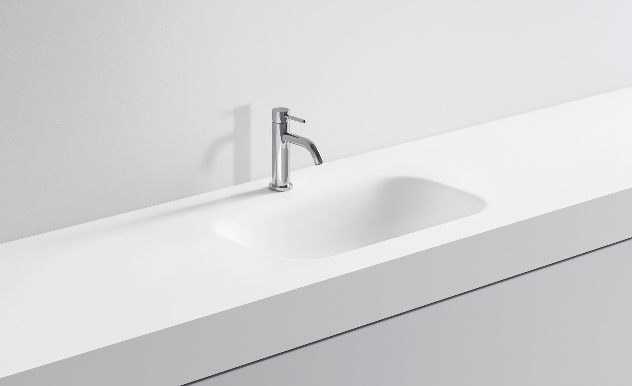 Lavabo bianco con rubinetto in acciaio inox in bagno minimalista.