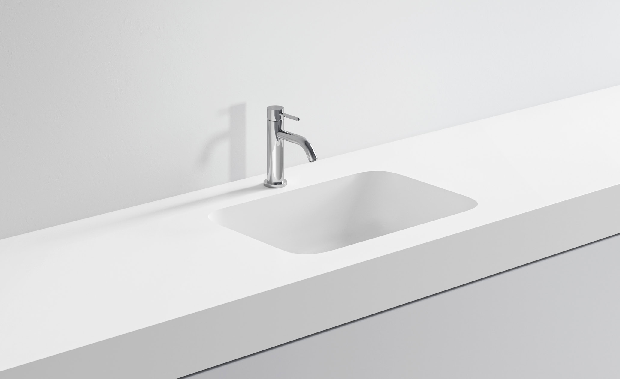 Lavabo bianco minimalista con rubinetto in acciaio inox.