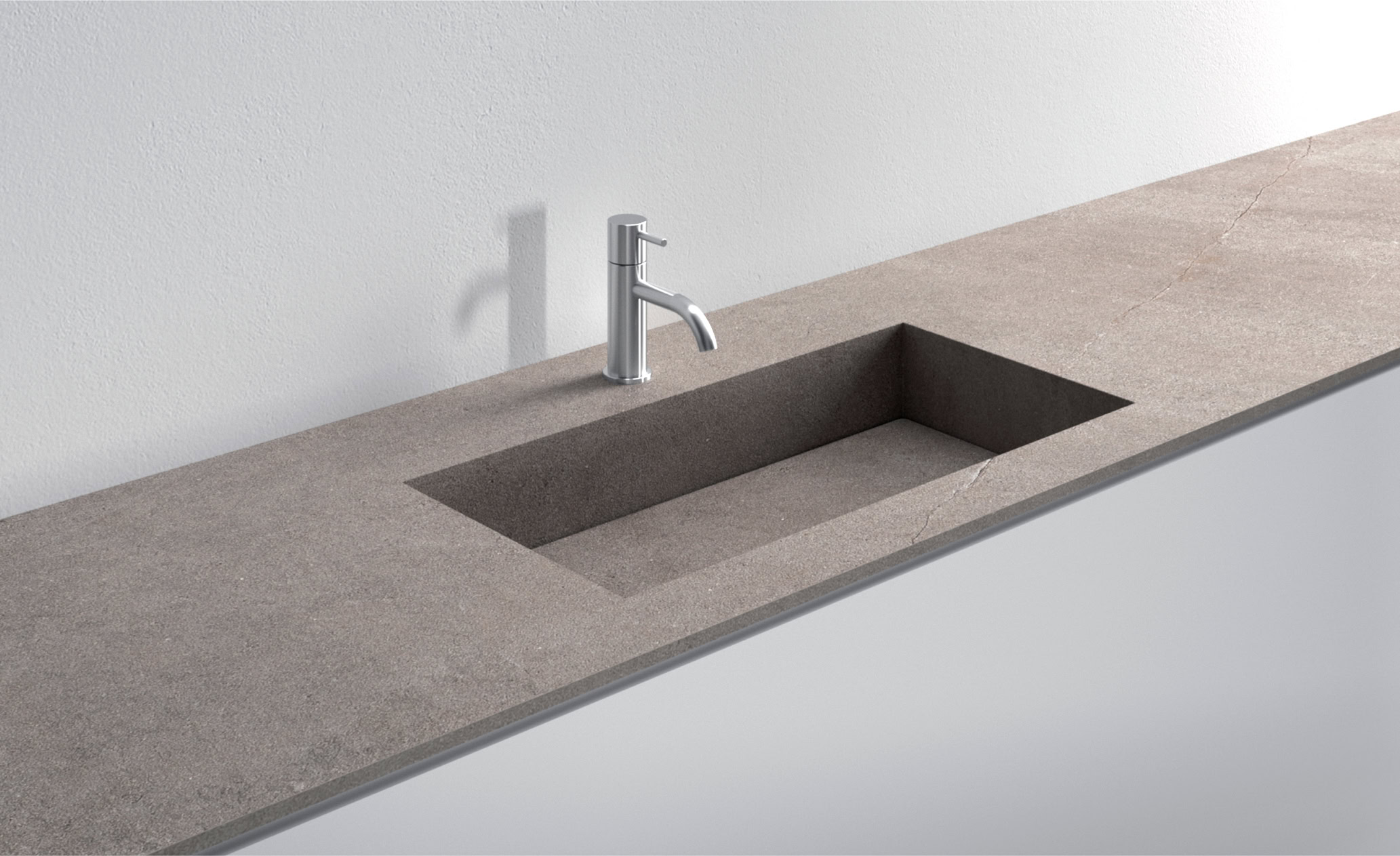 Lavello integrato in pietra naturale con rubinetto moderno.