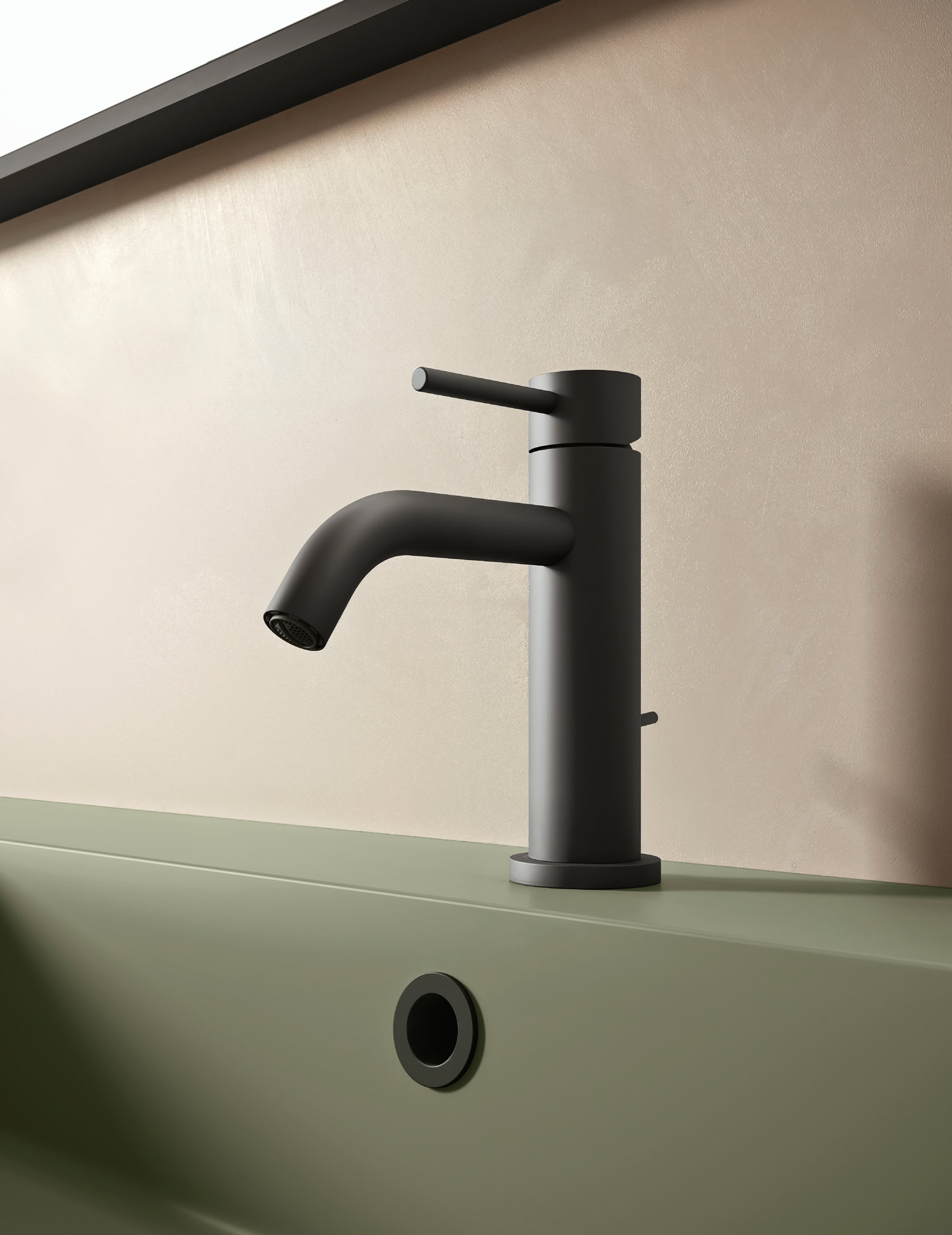 Rubinetto da cucina nero moderno su lavabo verde chiaro.