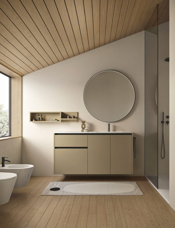 Bagno minimalista con lavabo, specchio rotondo e doccia.