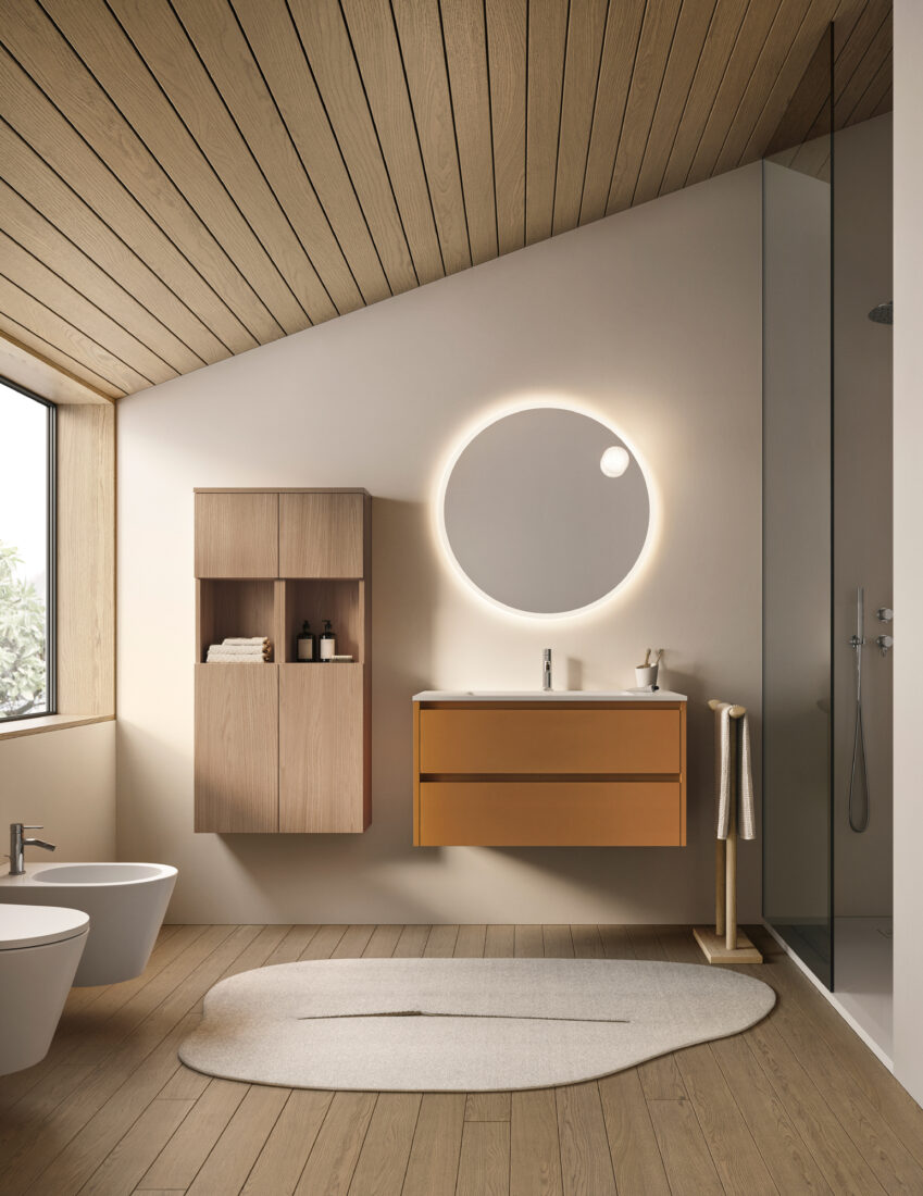 Bagno moderno con specchio rotondo illuminato e arredi minimalisti.