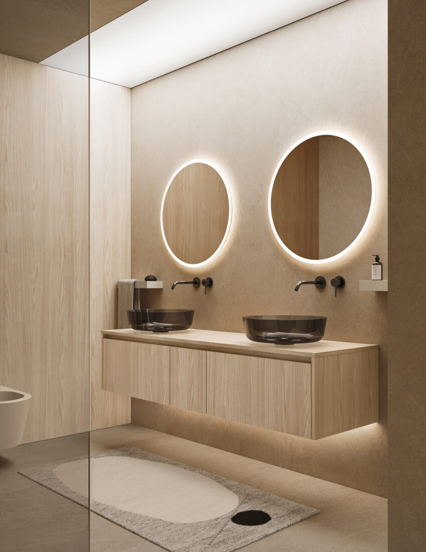 Bagno elegante con due specchi rotondi illuminati e lavabo sospeso in stile minimalista.