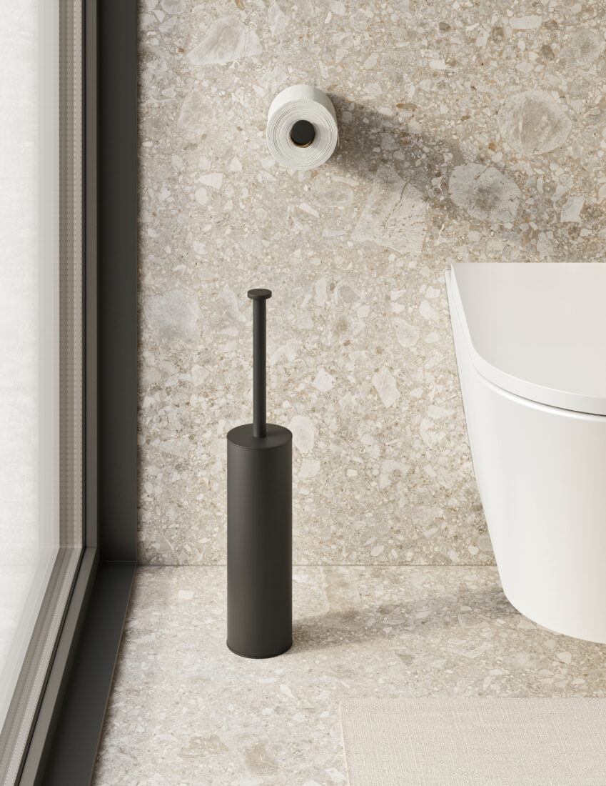 Pulsante di scarico WC e scopino in bagno moderno con pareti in pietra.