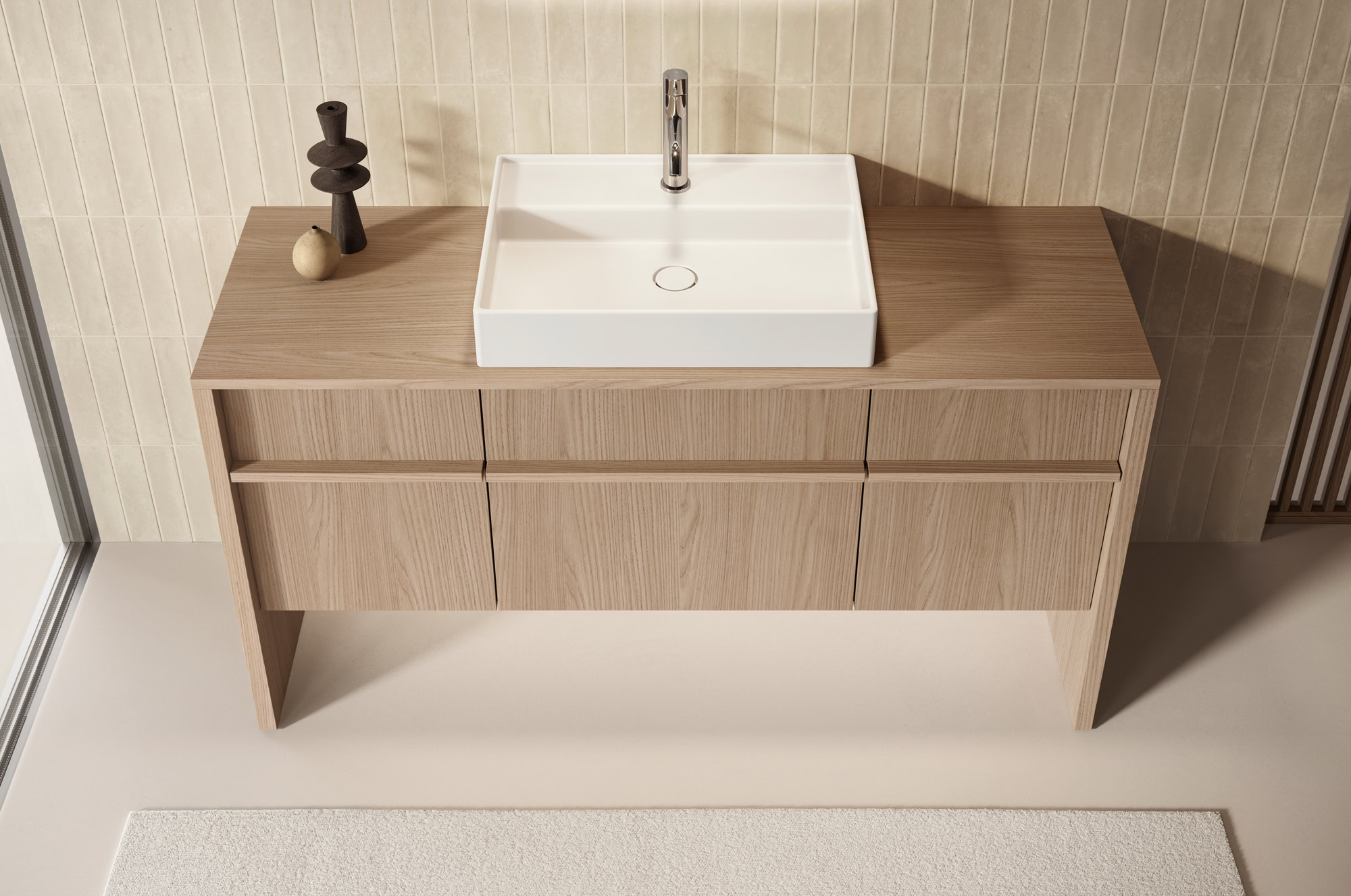 Contemporary bathroom vanity with a white sink and wooden cabinet.