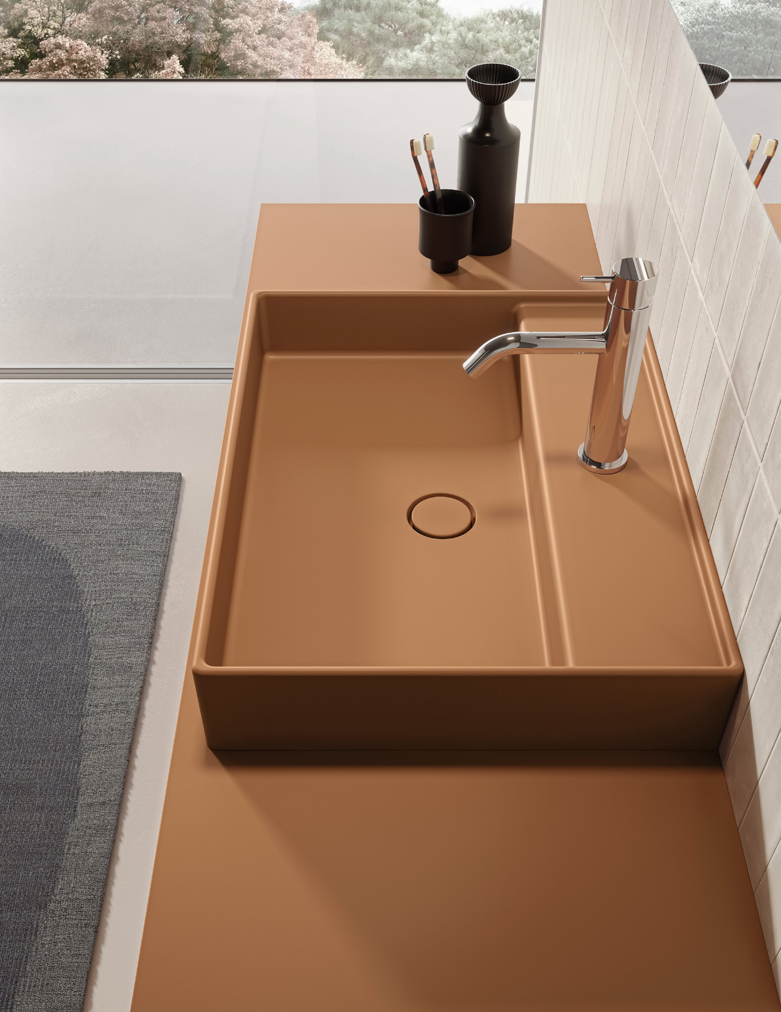 Contemporary bathroom sink with faucet and accessories in a minimalist design.