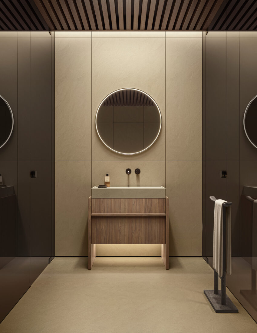Contemporary bathroom with round illuminated mirror and wooden vanity.