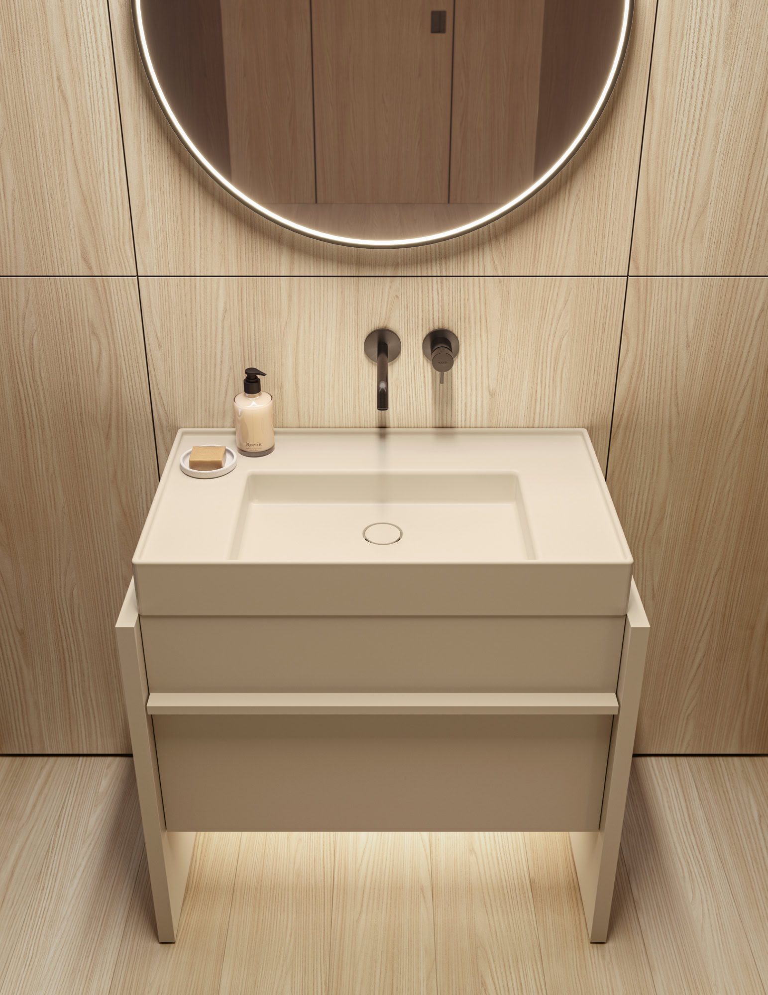 Contemporary bathroom vanity with round illuminated mirror and beige wall tiles.